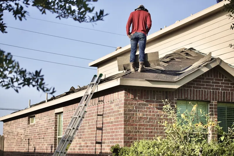 Professional roofer working on a residential roof in Harrison Park
